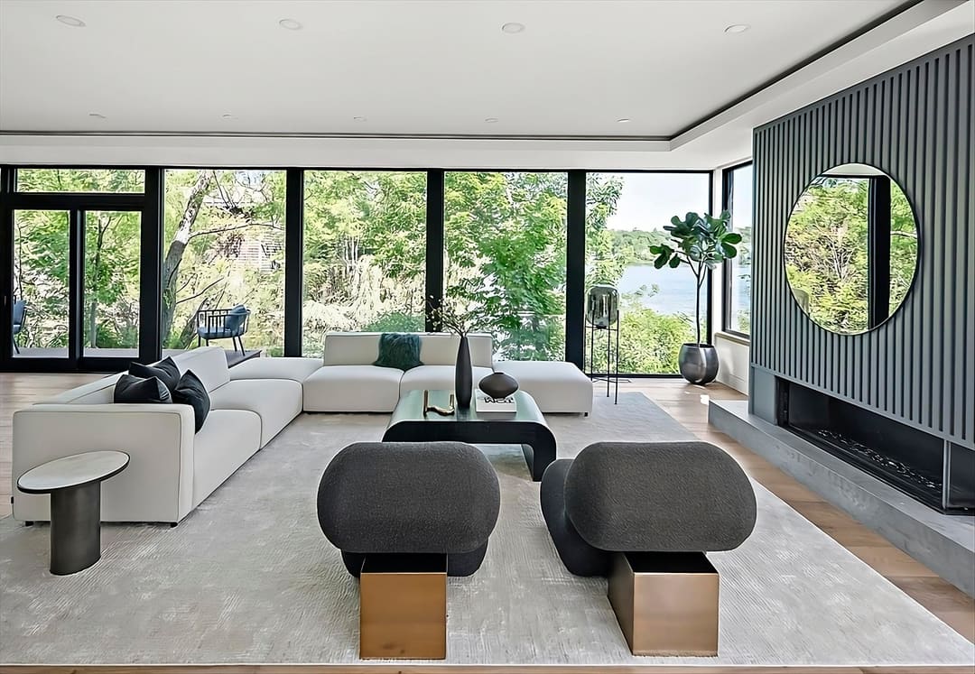 Interior of a completed Origin Funding development, looking out over water through floor-to-ceiling windows
