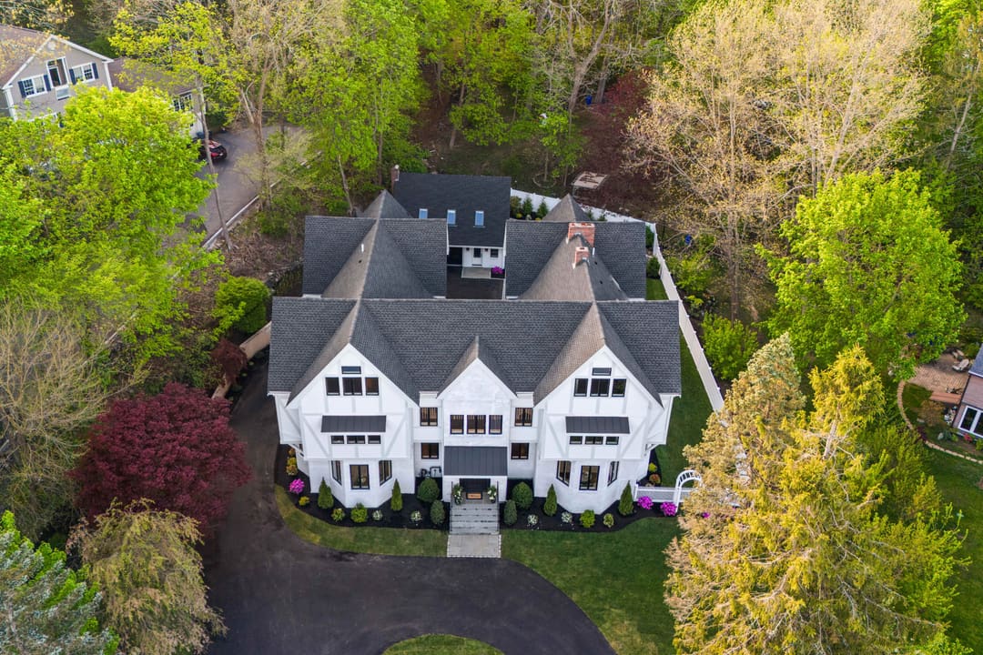 Aerial view of a completed large white residence in Eastern Massachusetts